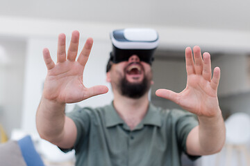 Image showing man with beard trying vr glasses