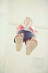 Image showing little boy standing on transparent glass floor