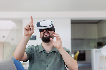 Image showing man with beard trying vr glasses