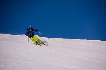 Image showing Skier having fun while running downhill