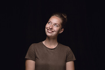 Image showing Close up portrait of young woman isolated on black studio background