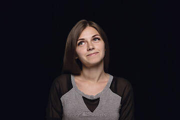 Image showing Close up portrait of young woman isolated on black studio background