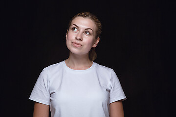 Image showing Close up portrait of young woman isolated on black studio background