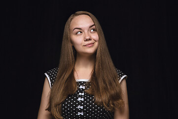 Image showing Close up portrait of young woman isolated on black studio background