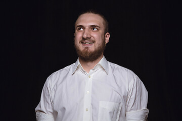 Image showing Close up portrait of young man isolated on black studio background