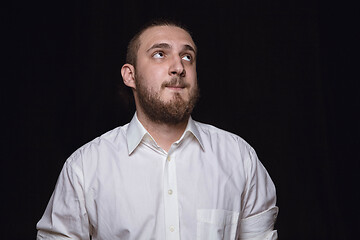 Image showing Close up portrait of young man isolated on black studio background