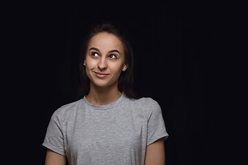 Image showing Close up portrait of young woman isolated on black studio background