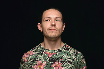 Image showing Close up portrait of young man isolated on black studio background