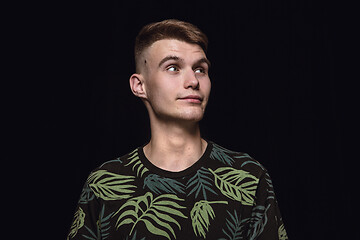 Image showing Close up portrait of young man isolated on black studio background