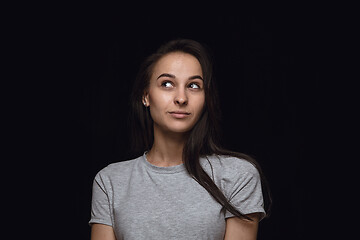 Image showing Close up portrait of young woman isolated on black studio background