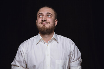 Image showing Close up portrait of young man isolated on black studio background