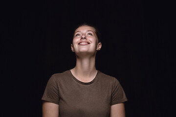 Image showing Close up portrait of young woman isolated on black studio background