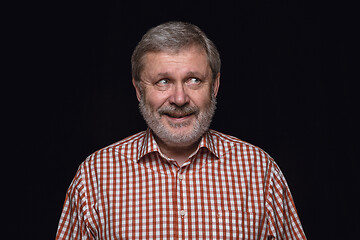 Image showing Close up portrait of senior man isolated on black studio background