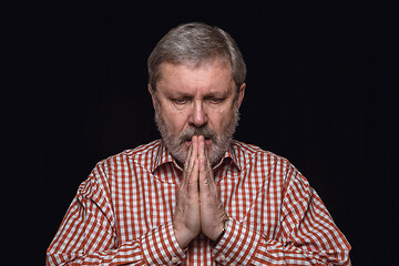 Image showing Close up portrait of senior man isolated on black studio background