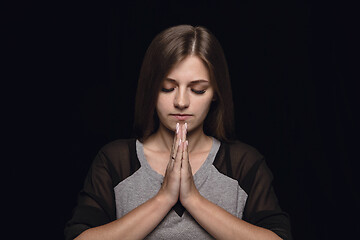 Image showing Close up portrait of young woman isolated on black studio background