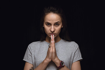 Image showing Close up portrait of young woman isolated on black studio background