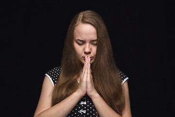 Image showing Close up portrait of young woman isolated on black studio background