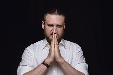 Image showing Close up portrait of young man isolated on black studio background