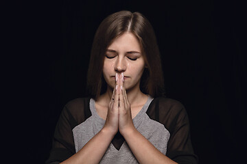 Image showing Close up portrait of young woman isolated on black studio background