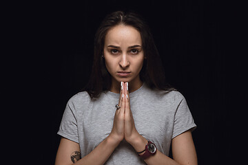 Image showing Close up portrait of young woman isolated on black studio background