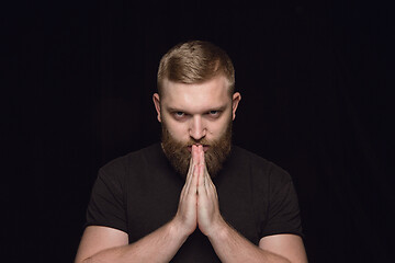 Image showing Close up portrait of young man isolated on black studio background