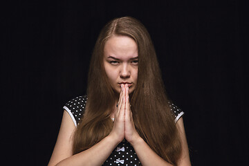 Image showing Close up portrait of young woman isolated on black studio background