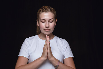 Image showing Close up portrait of young woman isolated on black studio background