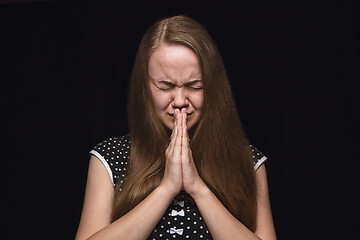 Image showing Close up portrait of young woman isolated on black studio background