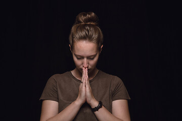 Image showing Close up portrait of young woman isolated on black studio background