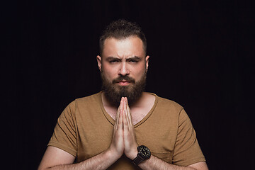 Image showing Close up portrait of young man isolated on black studio background