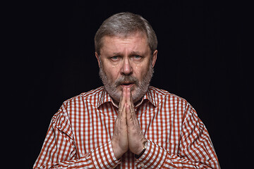 Image showing Close up portrait of senior man isolated on black studio background