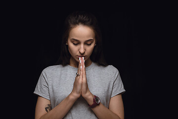 Image showing Close up portrait of young woman isolated on black studio background