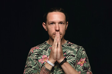 Image showing Close up portrait of young man isolated on black studio background