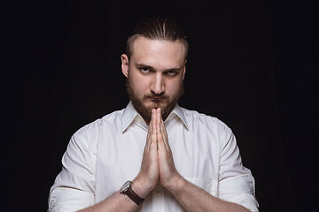 Image showing Close up portrait of young man isolated on black studio background