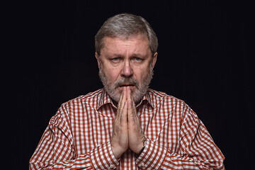 Image showing Close up portrait of senior man isolated on black studio background