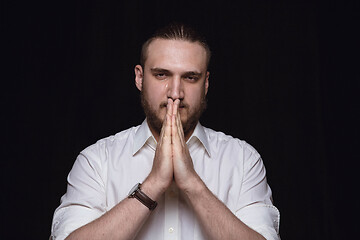 Image showing Close up portrait of young man isolated on black studio background