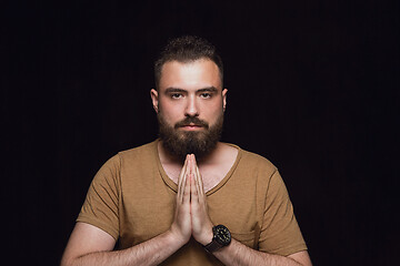 Image showing Close up portrait of young man isolated on black studio background