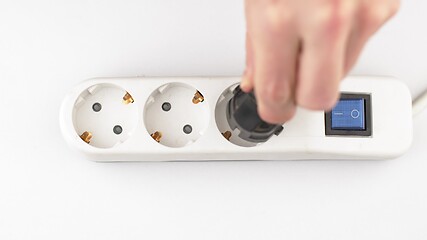 Image showing Filling Electric socket holes with electric plugs closeup footage