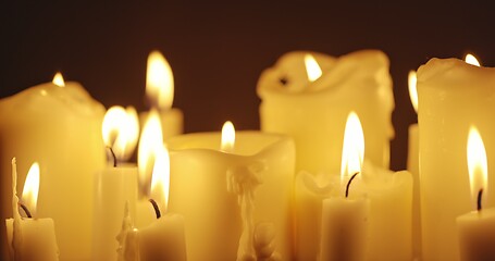 Image showing Candles glowing against dark background