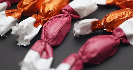 Image showing Christmas candy lying on the table with camera in motion closeup