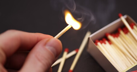 Image showing Lighting up Match in hand slow motion footage