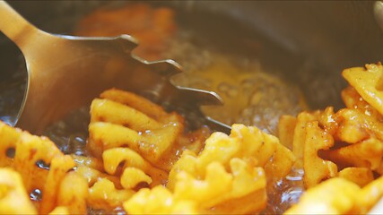 Image showing French fries boiling in sunflower oil