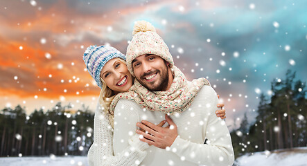 Image showing smiling couple in winter clothes hugging