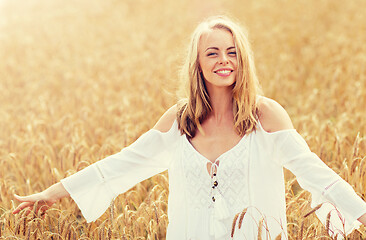 Image showing smiling young woman in white dress on cereal field