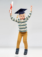 Image showing smiling little boy in mortar board with diploma