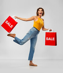 Image showing happy smiling young woman with shopping bags