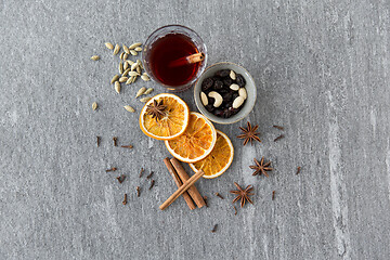 Image showing hot mulled wine, orange slices, raisins and spices