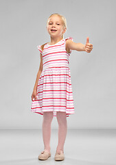 Image showing beautiful smiling little girl showing thumbs up