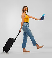 Image showing happy young woman with air ticket and travel bag