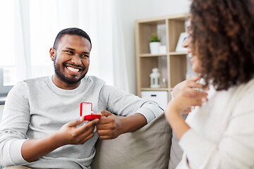 Image showing african american man giving woman engagement ring